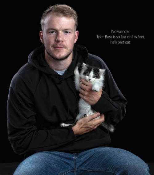 Tyler Bass holds a cat