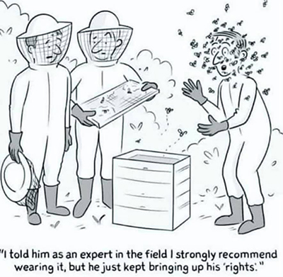 Man
surrounded by bees after rejecting warning from experts to wear protective clothing