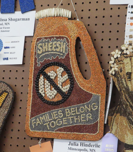 Bean art that uses various dried 
beans to re-create a bottle of detergent with the label 'sheesh' and 'ICE' with a circle and line through it, along 
with the comment 'Families belong together'