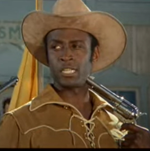 Cleavon Little's sheriff character
holds himself hostage while putting one over on the dumb white citizens of the town