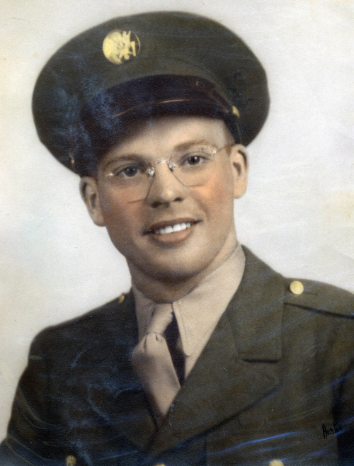 A handsome fellow, early 20s, in military dress uniform, with rosy cheeks and frameless glasses