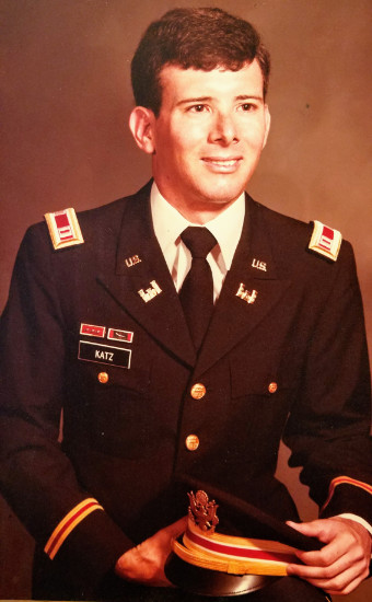 He's young, brown-haired, and
wearing a formal uniform with the rank on shoulder straps