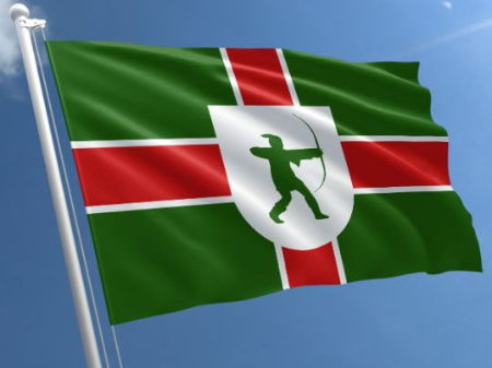 A green flag with a red cross
and a silhouette of Robin Hood firing a bow and arrow