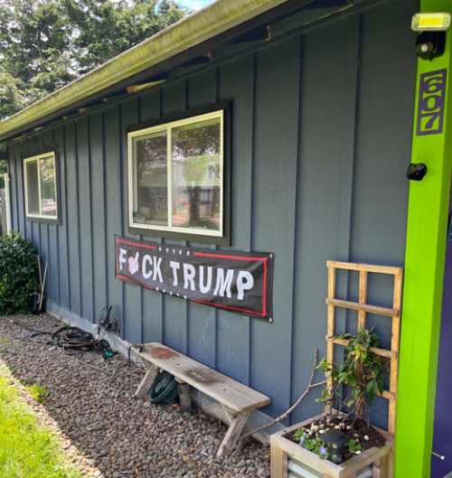A very nice modular 
home with a very large F*ck Trump banner