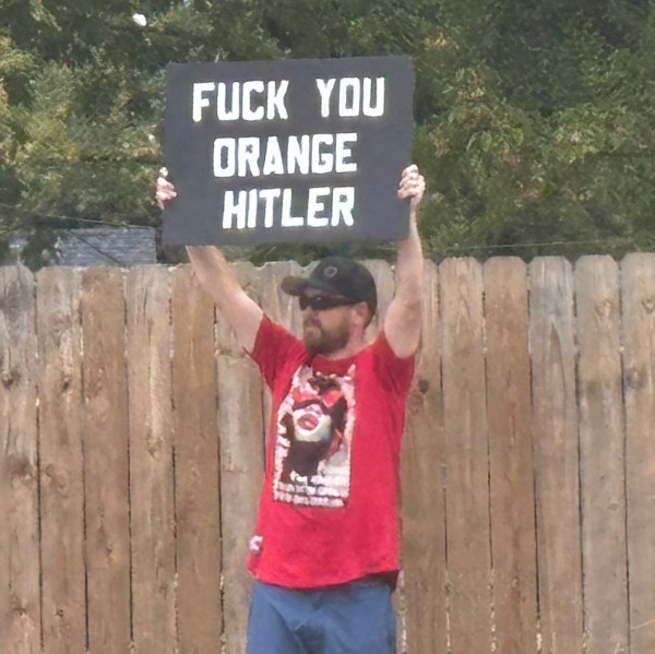The sign says 'Fuck You
Orange Hitler.'