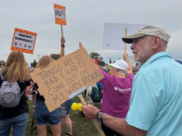 A man, presumably the letter
writer's husband, holds a sign that says 'THINGS ARE SO BAD I HAD TO COME OUT ON MY WIFE'S BIRTHDAY!'