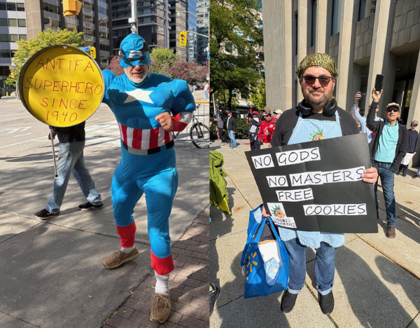 A man holds a sign that
says 'NO GODS, NO MASTERS, FREE COOKIES' and a different man is dressed as Captain America and holds a shield that says
'ANTIFA Superhero since 1940.'