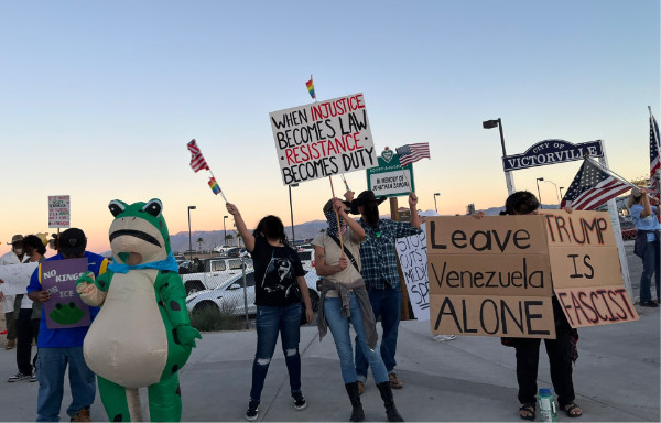 A decent crowd;
you can see a person in a frog costume, a person holding a sign that says 'WHEN INJUSTICE BECOMES LAW
RESISTANCE BECOMES DUTY,' and a person holding a sign that says 'Leave Venezuela ALONE.'