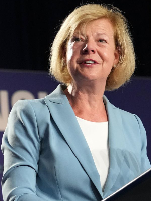 Tammy Baldwin standing at a podium and speaking