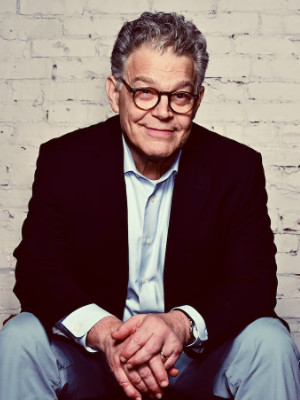 Franken sitting and looking at
the camera with a mischievous smile on his face