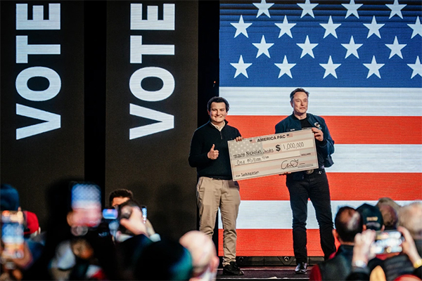 Musk holding a million dollar check he gave a voter