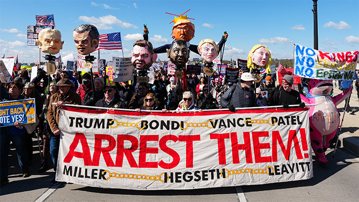 No Kings Day sign; it says 'ARREST THEM' and lists Trump, Bondi, Hegseth,
Vance, Patel, Miller and Leavitt