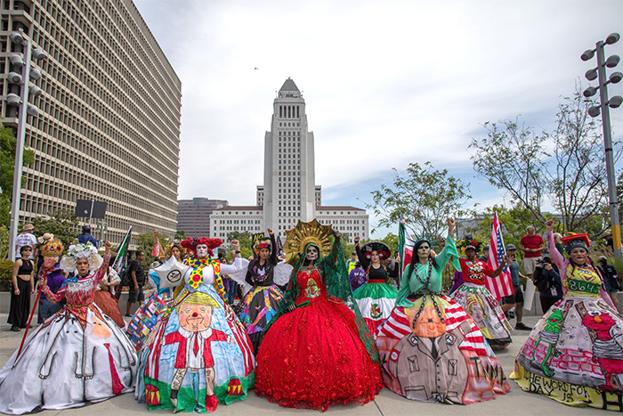 A bunch of people in Los Angeles in 'Alice in Wonderland' type queen
costumes
