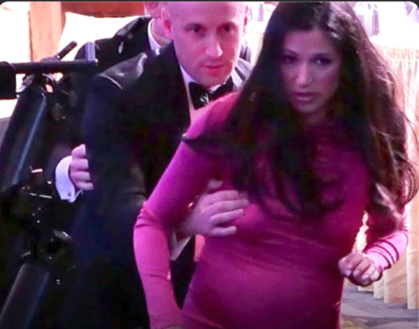 Stephen Miller and his wife; he is behind her, and his hand is all over her right breast