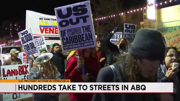 A large number of people
carry signs that say things like 'No Blood for Oil' and 'U.S. out of the Caribbean'