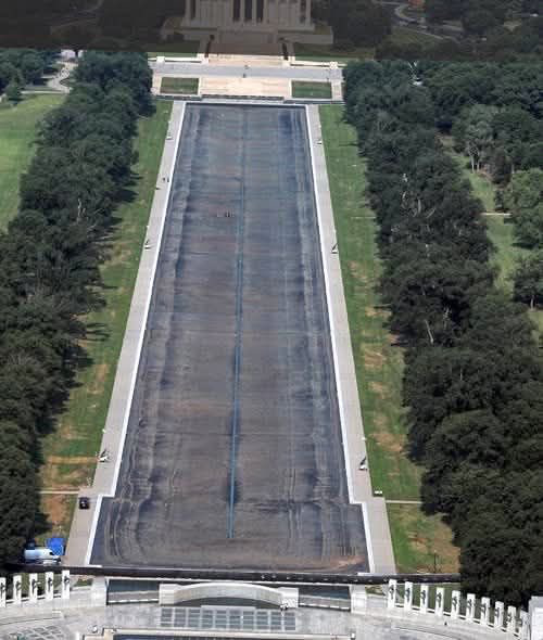 A shot of the reflecting pool
taken from above, showing that it is completely empty, with a black-tar-like surface.