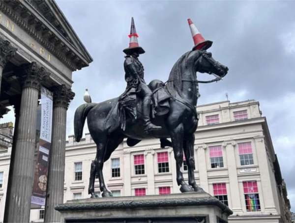 A bronze equestrian statue,
probably of Civil War vintage, with traffic cones on both the horse's and rider's heads.