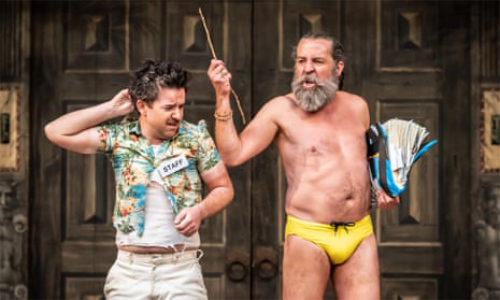 A younger man is wearing 
a costume that suggests he is a hotel clerk, an older man is wearing a yellow speedo; it's clear this staging of the play
was set in Hawaii or some other beachy locale