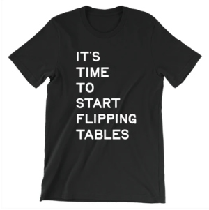 A black shirt with white
type says 'It's time to start flipping tables.'
