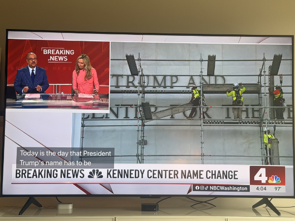 A photo of the reader's TV;
the news broadcast is showing footage of the workers erecting the necessary scaffolding to remove Trump's name from the Kennedy 
Center.