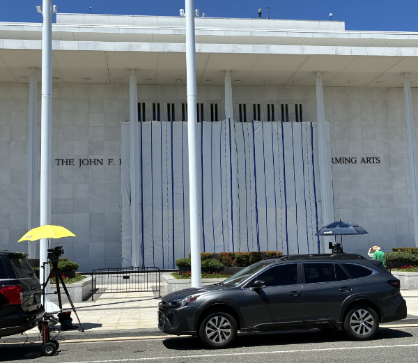 The front of the Kennedy
Center, with a giant tarp up in front of it, such that the only lettering visible is 'The John F.' on one side
of the tarp, and 'Ming Arts' on the other.